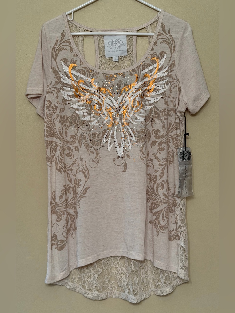 Maurices short-sleeve top featuring intricate lace detailing and graphic design